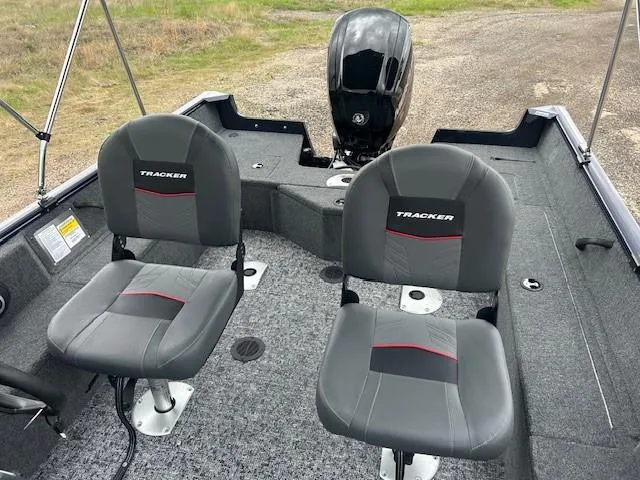 Slide: The Image of 2025 Tracker Pro Guide V-16 SC boat interior with two seats and motor. - 13