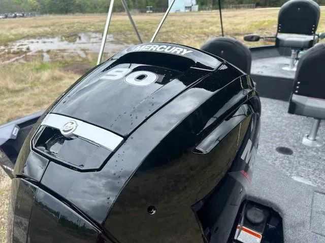 Slide: The Image of 2025 Tracker Pro Guide V-16 SC with Mercury 90 engine, parked on grassy terrain. - 14