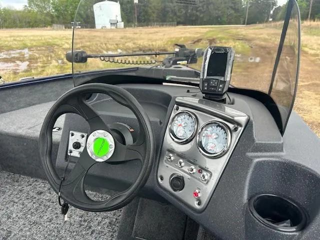 Slide: The Image of 2025 Tracker Pro Guide V-16 SC boat dashboard with steering wheel and gauges. - 15