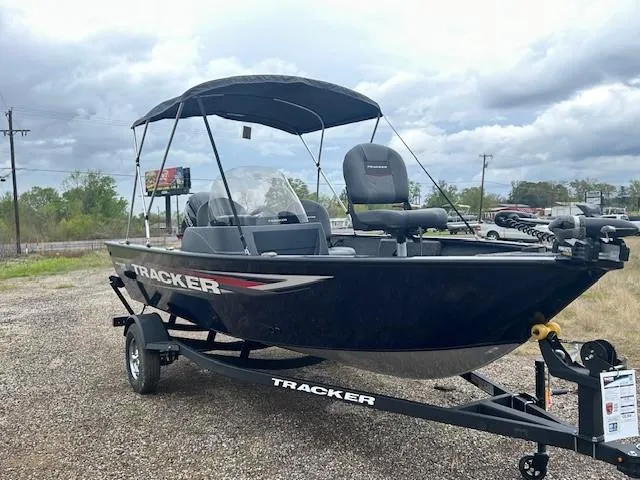 Slide: The Image of 2025 Tracker Pro Guide V-16 SC boat on trailer, parked outdoors under cloudy sky. - 3