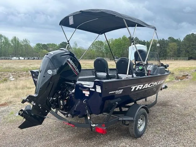 Slide: The Image of 2025 Tracker Pro Guide V-16 SC boat with Mercury engine on trailer, parked outdoors. - 5