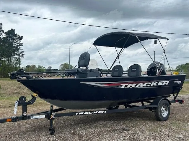 Slide: The Image of 2025 Tracker Pro Guide V-16 SC boat on trailer, parked outdoors under cloudy sky. - 8