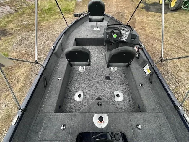 Slide: The Image of 2025 Tracker Pro Guide V-16 SC boat interior with seating and steering console. - 9