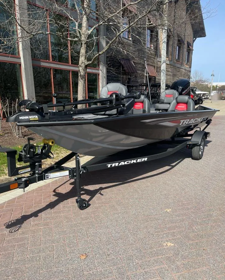 Slide: The Image of 2025 Tracker Pro Team 175 boat parked outdoors on a sunny day. - 2