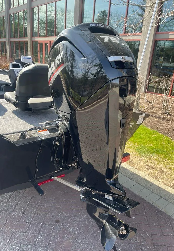 Slide: The Image of 2025 Tracker Pro Team 175 boat with Mercury outboard motor, parked outdoors. - 8