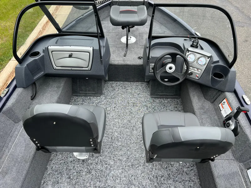 Slide: The Image of 2025 Tracker Pro Guide V-16 WT boat interior with steering wheel and seating. - 6