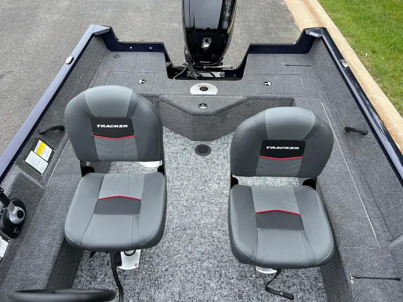 Slide: The Image of 2025 Tracker Pro Guide V-16 WT boat interior with two gray seats. - 7