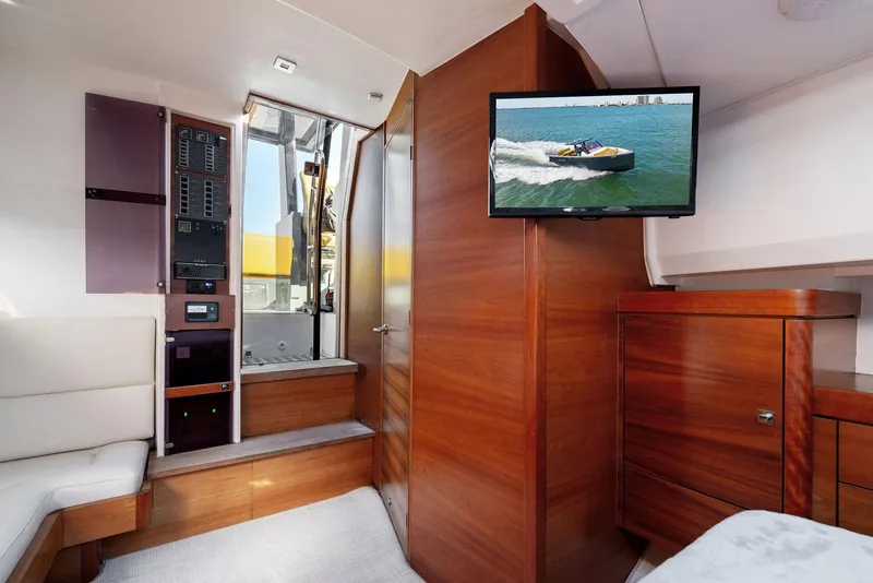 Slide: The Image of Interior of 2011 Fjord 40 Open yacht with wood paneling and mounted TV. - 10
