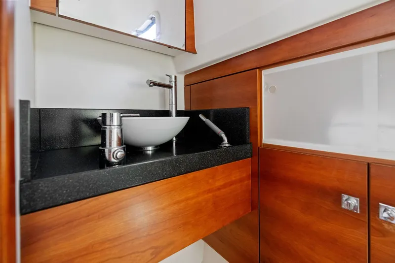 Slide: The Image of Luxurious bathroom interior of 2011 Fjord 40 Open yacht with modern sink and wood finish. - 11