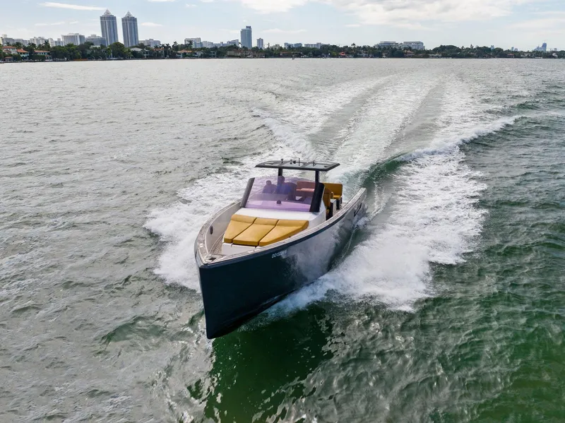 Slide: The Image of 2011 Fjord 40 Open yacht cruising on a scenic waterway with city skyline backdrop. - 17