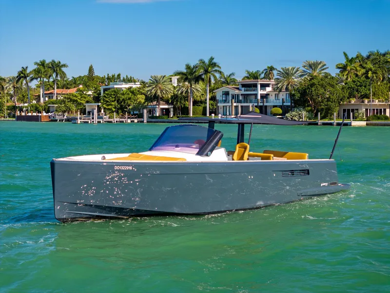 Slide: The Image of Fjord 40 Open 2011 yacht cruising on turquoise water near luxury waterfront homes. - 2