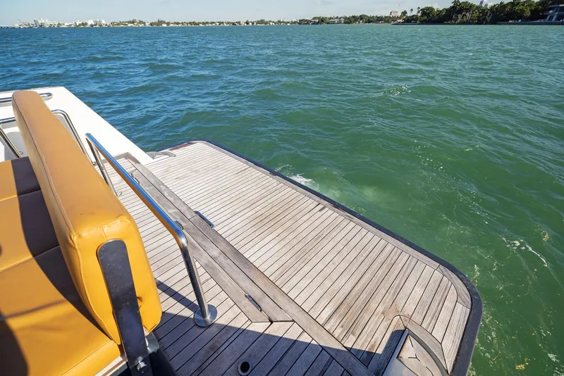 Slide: The Image of Fjord 40 Open 2011 boat with teak deck and yellow seating on calm water. - 21