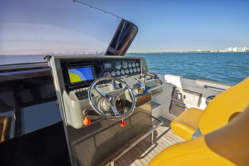 Slide: The Image of Helm of 2011 Fjord 40 Open yacht with navigation system, steering wheel, and ocean view. - 24