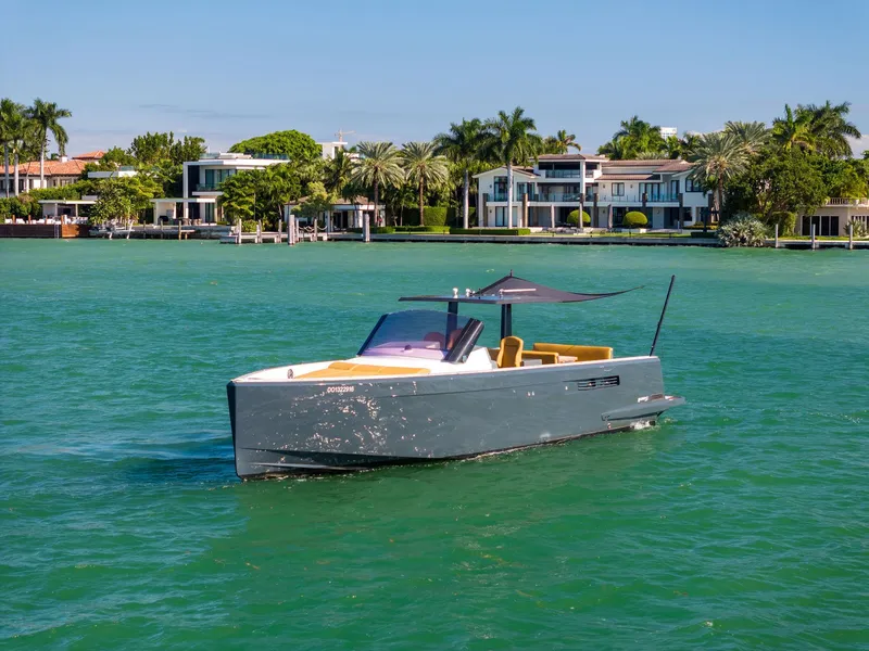 Slide: The Image of Fjord 40 Open 2011 yacht cruising on turquoise waters near luxury waterfront homes. - 48