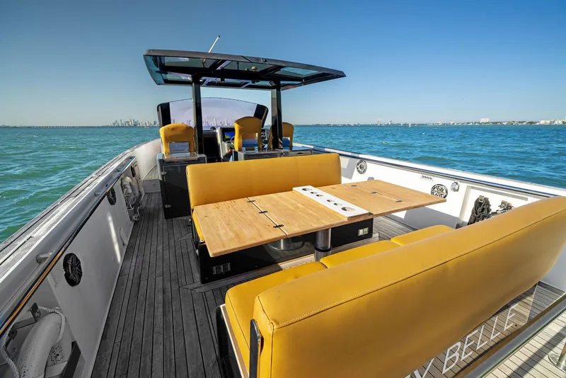 Slide: The Image of Luxurious 2011 Fjord 40 Open yacht with yellow seating and wooden deck on open water. - 6