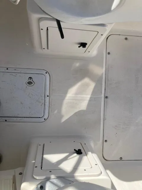 Slide: The Image of 2005 Sea Hunt Victory 225 boat interior with storage compartments and seating. - 11