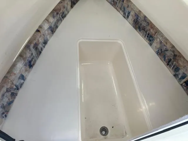 Slide: The Image of 2005 Sea Hunt Victory 225 boat interior with storage compartment. - 7