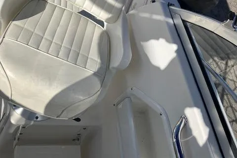 Slide: The Image of 2005 Sea Hunt Victory 225 boat interior with white seating and sleek design. - 9