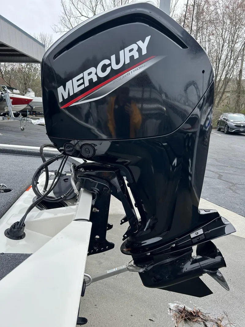 Slide: The Image of 2022 Bass Tracker PRO TEAM 175 TXW with Mercury outboard motor in parking lot. - 10