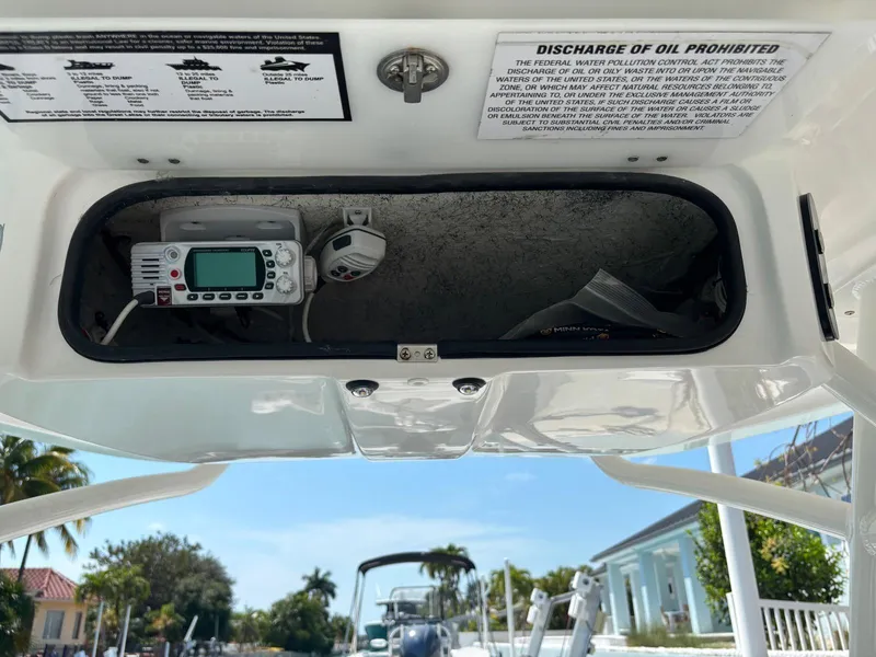 Slide: The Image of 2023 Glasstream 280 Pro-XS boat console with radio and safety instructions. - 10