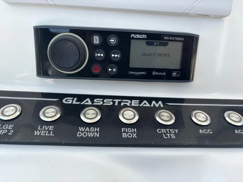 Slide: The Image of Control panel of 2023 Glasstream 280 Pro-XS with Fusion audio system and labeled buttons. - 11