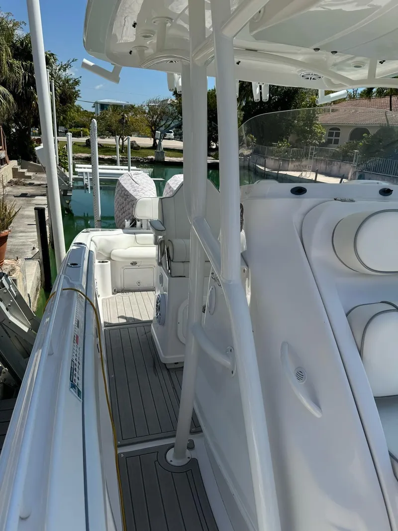 Slide: The Image of 2023 Glasstream 280 Pro-XS boat docked, showcasing sleek design and spacious deck layout. - 12