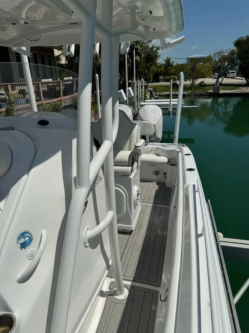 Slide: The Image of 2023 Glasstream 280 Pro-XS boat docked, showcasing sleek design and spacious deck. - 13