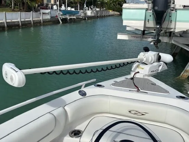 Slide: The Image of 2023 Glasstream 280 Pro-XS boat with trolling motor in a marina setting. - 21