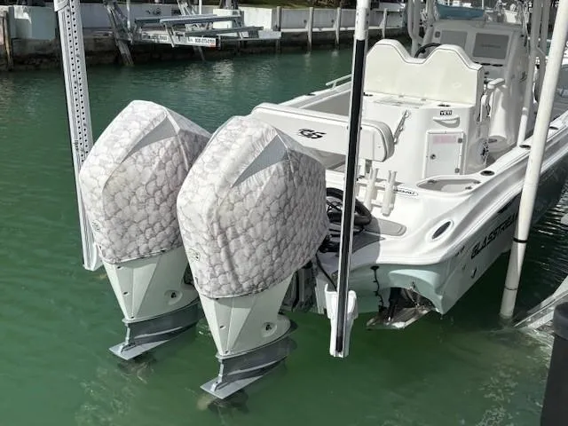 Slide: The Image of 2023 Glasstream 280 Pro-XS boat with dual covered outboard motors docked in marina. - 22