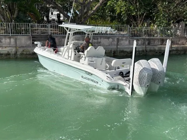 Slide: The Image of 2023 Glasstream 280 Pro-XS boat cruising in a canal with dual engines. - 25