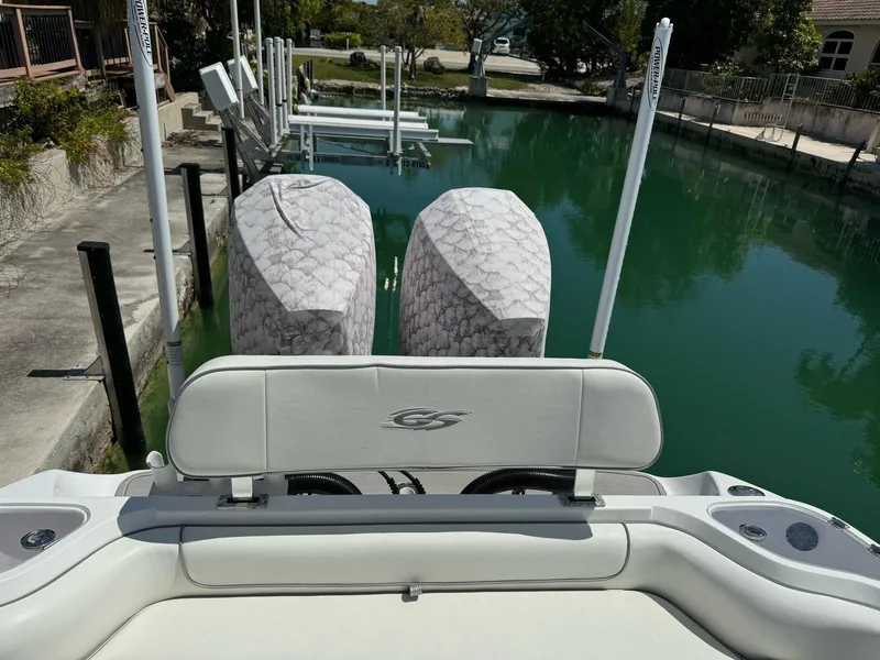 Slide: The Image of 2023 Glasstream 280 Pro-XS boat with dual covered engines docked in a serene canal. - 6