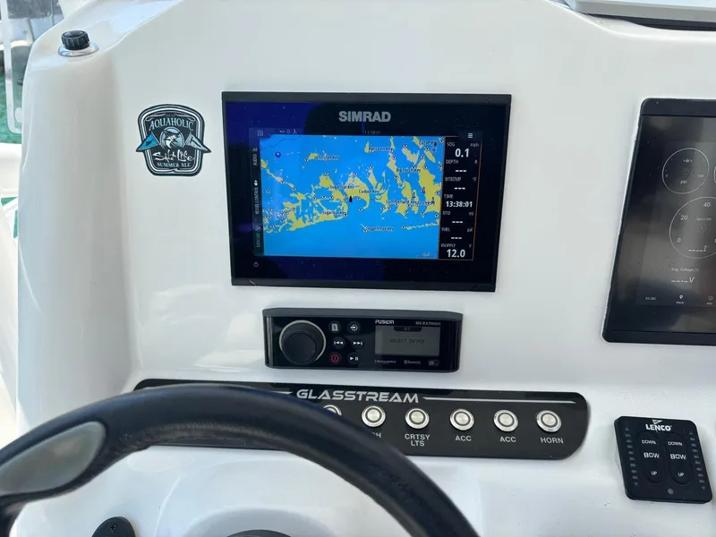 Slide: The Image of 2023 Glasstream 280 Pro-XS dashboard with Simrad navigation display and controls. - 7