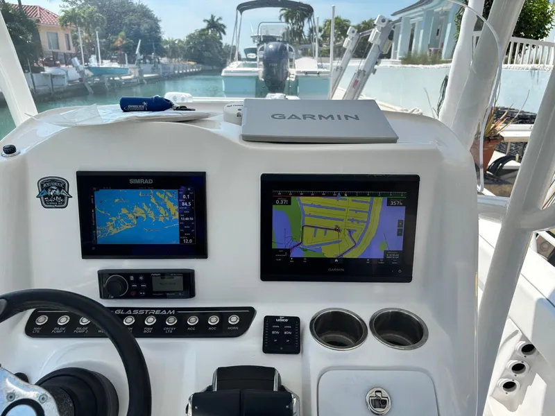 Slide: The Image of 2023 Glasstream 280 Pro-XS boat dashboard with Garmin navigation displays. - 9