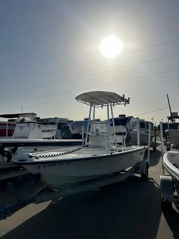 Slide: The Image of 2010 Mako 18 Inshore boat on trailer under bright sun in marina. - 2