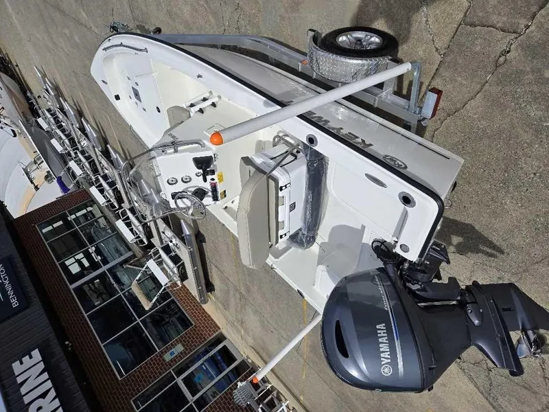Slide: The Image of 2025 Key West 1720 CC boat with Yamaha engine on trailer, parked outside a building. - 3
