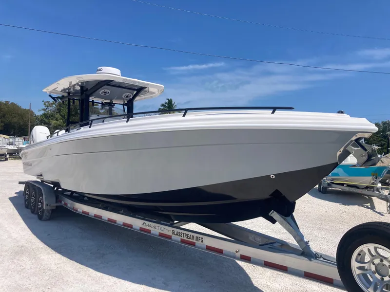 Slide: The Image of 2022 Glasstream 36 PRO boat on trailer, sleek design, parked outdoors under clear blue sky. - 1
