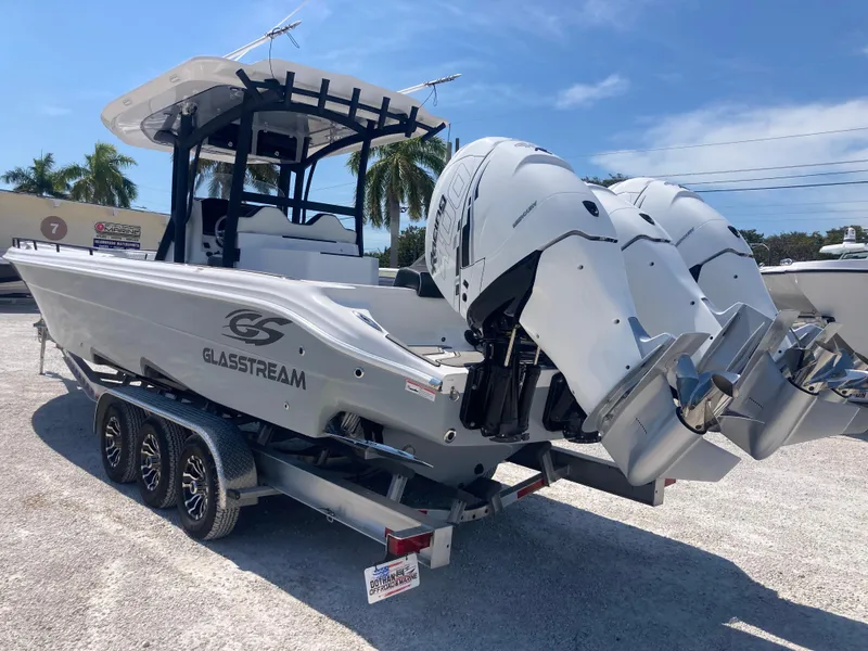 Slide: The Image of 2022 Glasstream 36 PRO boat on trailer with dual engines, parked outdoors. - 4