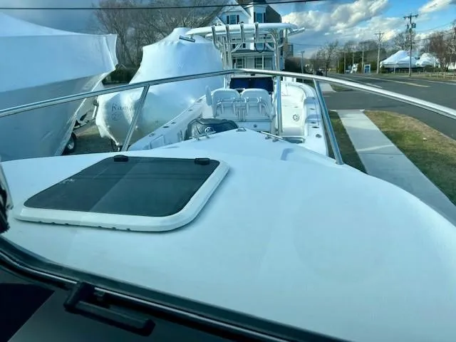 Slide: The Image of 2020 Parker 2320 SL Sport Cabin boat docked, showcasing deck and cabin features. - 10