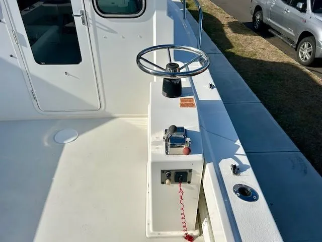 Slide: The Image of 2020 Parker 2320 SL Sport Cabin boat helm with steering wheel and controls. - 13