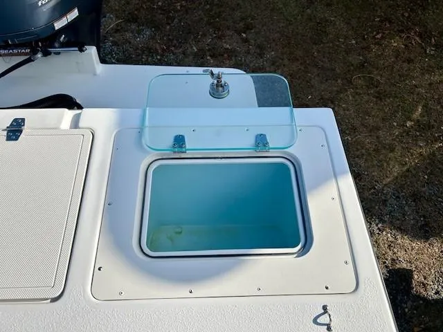 Slide: The Image of Open hatch on 2020 Parker 2320 SL Sport Cabin boat, showing storage compartment. - 14