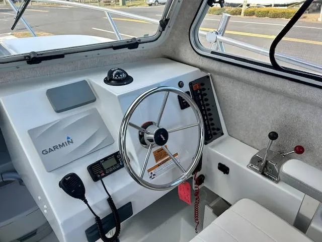 Slide: The Image of 2020 Parker 2320 SL Sport Cabin boat interior with steering wheel and Garmin navigation system. - 6