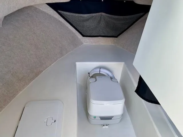 Slide: The Image of 2020 Parker 2320 SL Sport Cabin interior with portable toilet and storage compartment. - 8