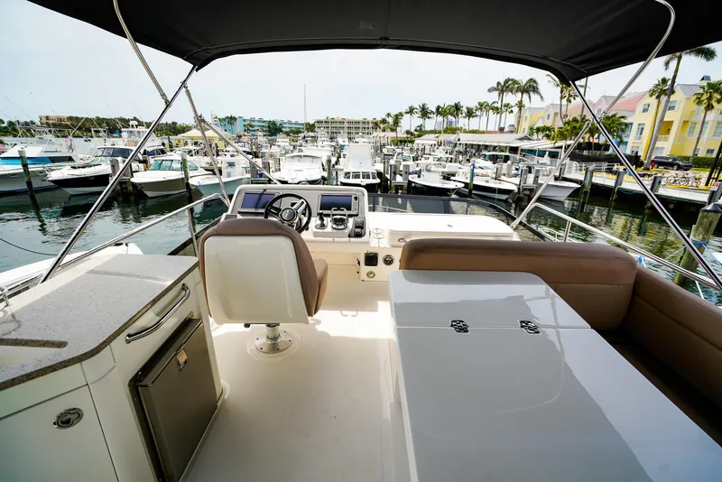 Slide: The Image of Flybridge view of 2016 Sea Ray 400 Fly yacht docked at marina. - 11