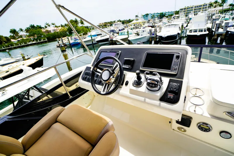 Slide: The Image of Cockpit view of 2016 Sea Ray 400 Fly yacht at marina. - 12