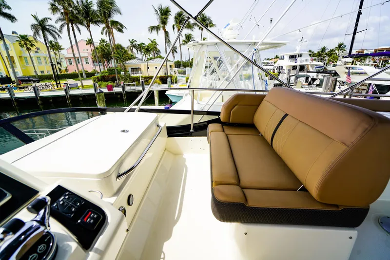 Slide: The Image of Flybridge seating on 2016 Sea Ray 400 Fly yacht, docked with palm trees in background. - 14