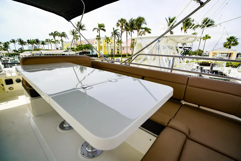 Slide: The Image of Luxurious 2016 Sea Ray 400 Fly yacht with sleek outdoor seating and table. - 16