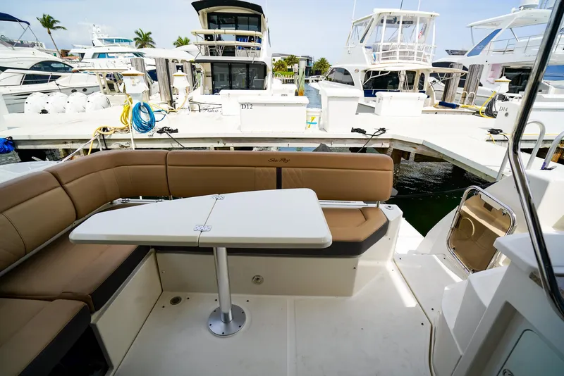 Slide: The Image of Luxurious 2016 Sea Ray 400 Fly yacht with spacious outdoor seating and table at marina. - 21