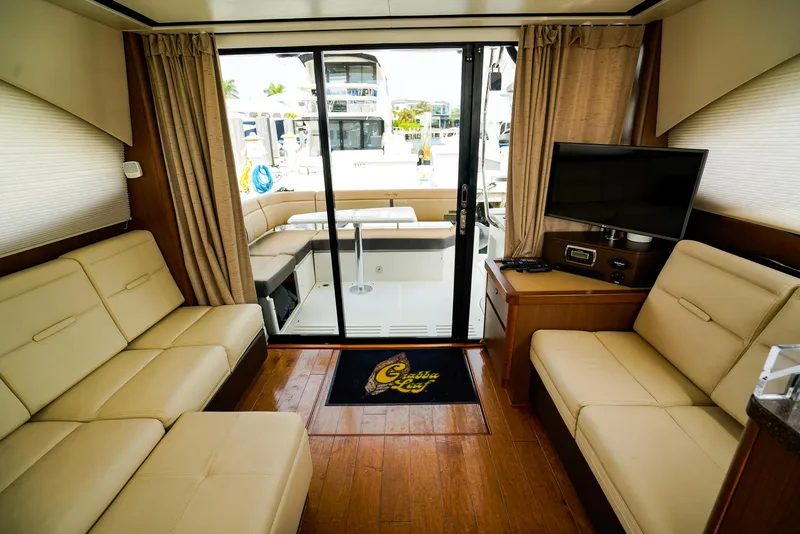 Slide: The Image of Luxurious interior of 2016 Sea Ray 400 Fly yacht with beige seating and modern amenities. - 28