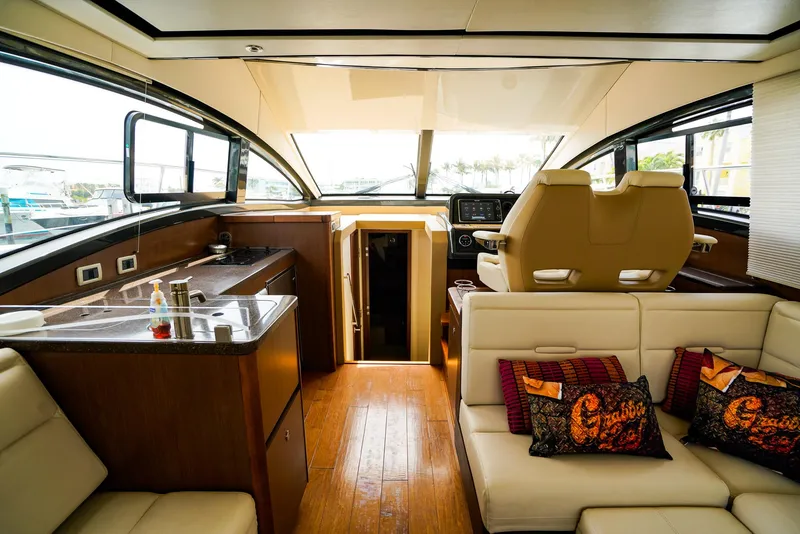 Slide: The Image of Luxurious interior of 2016 Sea Ray 400 Fly yacht with modern seating and helm. - 29