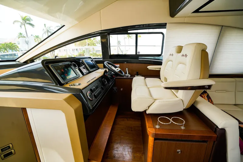 Slide: The Image of 2016 Sea Ray 400 Flybridge helm with modern controls and luxurious seating. - 32